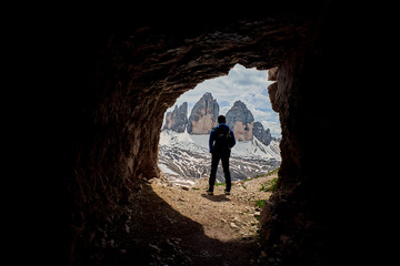 A hiker with Tre Cime di Lavaredo in the background, Dolomites, Italy