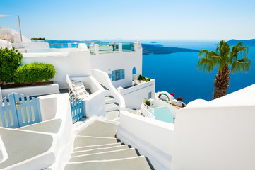 Fototapeta na wymiar White cycladic architecture and blue sea on Santorini island, Greece. Summer holidays, travel destinations concept
