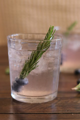 Gin summer cocktail seasonal with blueberry and rosemary