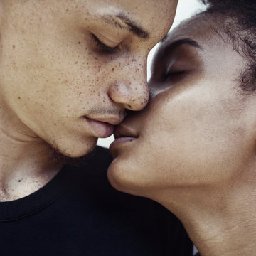 Close-up portrait of a couple about to kiss