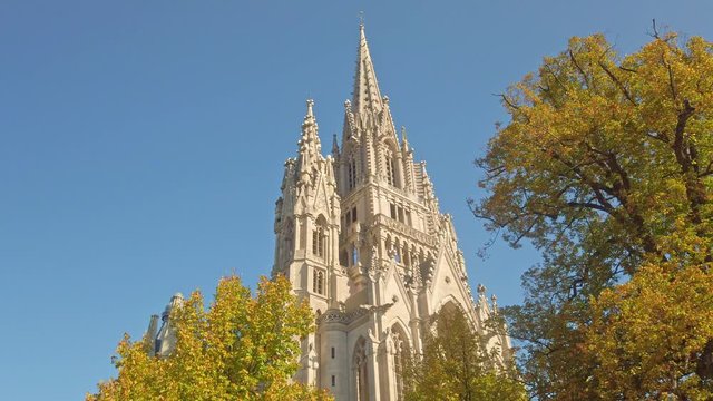 Still shot of gothic church spires steeple reaching high above the trees Brussels Belgium
