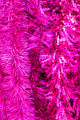 pink shiny christmas garland. Festive background for greeting card for new year holidays.