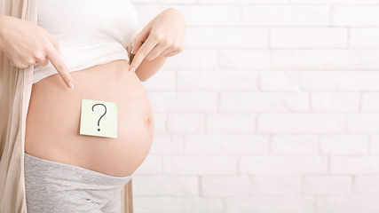 Pregnant woman belly with question mark, panorama