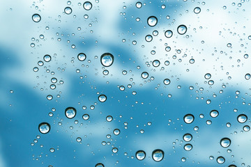 Rain on the window, natural skin of the rain The natural form of rainwater on a sky background.