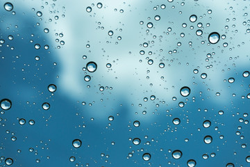 Rain on the window, natural skin of the rain The natural form of rainwater on a sky background.