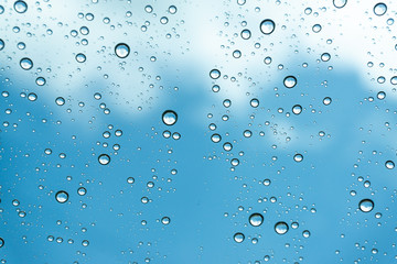 Rain on the window, natural skin of the rain The natural form of rainwater on a sky background.