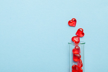 Hearts and test tube. Baby from tube vitro glass. Artificial insemination, IVF. Blue background....