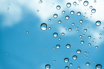 Rain on the window, natural skin of the rain The natural form of rainwater on a sky background.