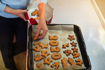 Portrait of hands woman put cookies in box with lid in kitchen