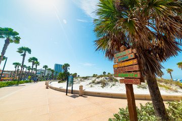 Wooden direction and distance signs in beautiful Clearwater seafront - obrazy, fototapety, plakaty