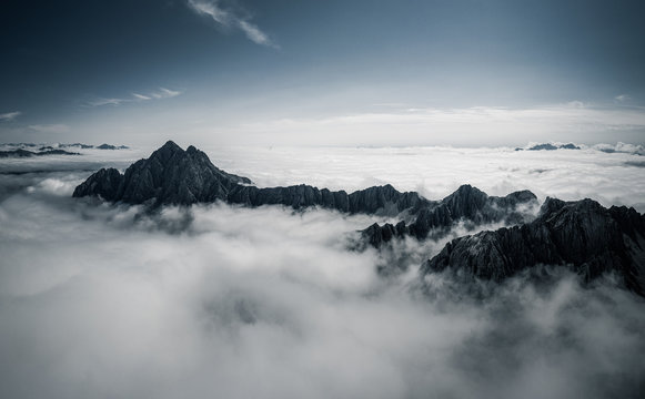 Mountain peaks above clouds, Dolomites, Lienz, Austria