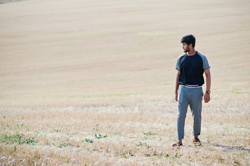 Indian man at casual wear posed at field alone.