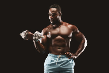 Bodybuilder working on his arms muscles, using one barbell