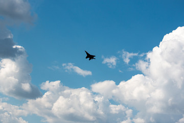 military aircraft flying in the background of clouds