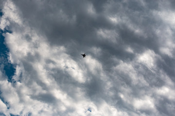 military aircraft flying in the background of clouds