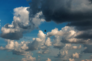 military aircraft flying in the background of clouds