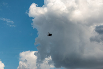 military aircraft flying in the background of clouds