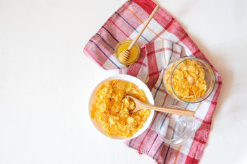 Traditional breakfast cereal of cornflakes and milk with a banana. Healthy lifestyle food.