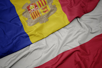 waving colorful flag of poland and national flag of andorra.