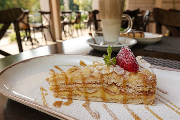 A slice of delicious sandwich puff cake with strawberries on a dish