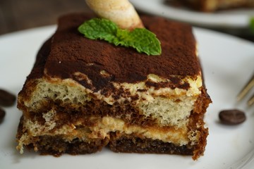 Square slice of Tiramisu cake, selective focus