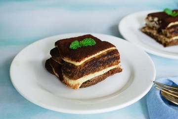 Square slice of Tiramisu cake, selective focus