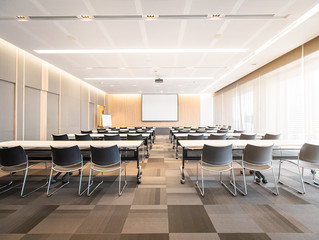 Big empty modern meeting, Presentation Screen board Seminar room interior Seat row,Conference room for Business training, large windows outside building city