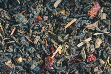 Texture of dry herbal tea with berries and leaves, ingredient drink abstraction background. Texture of dry herbal tea with berries