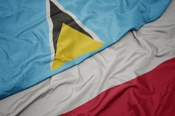 waving colorful flag of poland and national flag of saint lucia.
