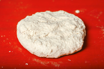 close up of flour dough on table, baking concept