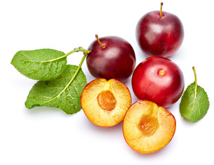 Fresh plum in cut with green leaf. Fruity still life. Healthy food. Isolated on white background.