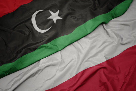 waving colorful flag of poland and national flag of libya.