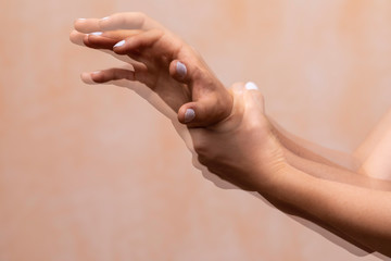 A closeup view on the violently shaking hands of a PD sufferer (Parkinson's disease), tremors of the wrist and hand joints are the main symptom of the disorder.
