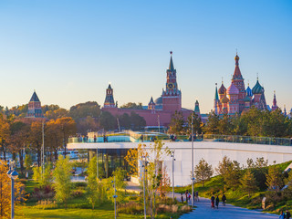 Beautiful view of Zaryadye landscape park with the steeples of the Kremlin and the St Basil`s Cathedral in the background on a sunny autumn evening.