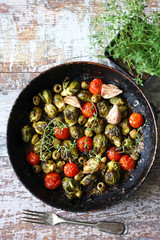 Baked Brussels sprouts in a pan with cherry tomatoes, garlic and olives. Vegan food. Diet concept. Autumn food.