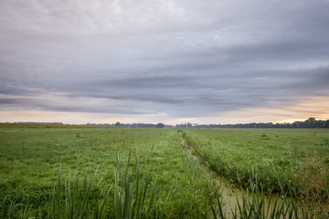 Beautiful dramatic clouds over the wide open landscape near Gouda, Netherlands