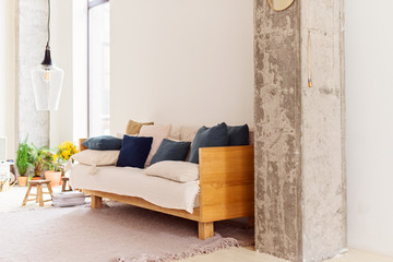 Couch with pillows in modern living room in the style of hugge