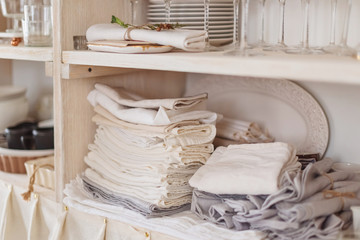 Wooden rack with textiles and dishes, modern interior