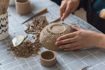 Pottery workshop, the process of making ceramic tableware, women's hands - obrazy, fototapety, plakaty