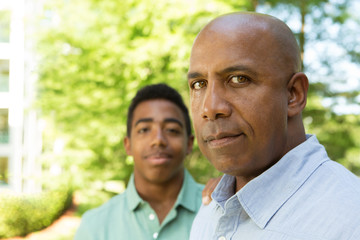 Fototapeta premium African American father and teenage son outside.