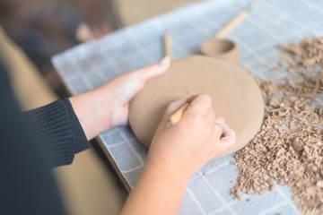 Fototapeta premium Pottery workshop, the process of making ceramic tableware, women's hands
