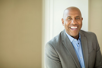 Happy mature African American man at work.