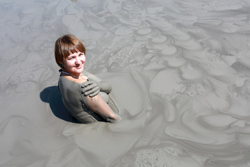 Fototapeta premium Woman resting in mud pond