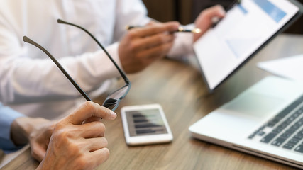 Business team brainstorming and discussing with financial data and report graph. Teamwork meeting working concept.