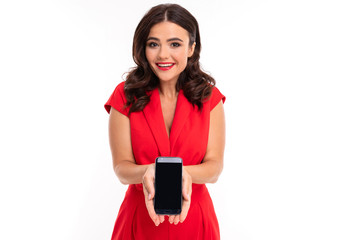 Naklejka premium charming brunette holds a phone in her hand carefully