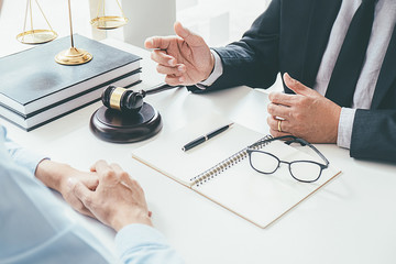 Judge gavel with Justice lawyers having team meeting at law firm background. Concepts of Law and...