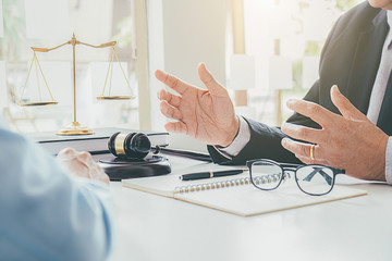 Judge gavel with Justice lawyers having team meeting at law firm background. Concepts of Law and...