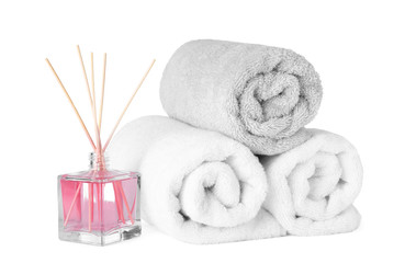 Obraz na płótnie Canvas Clean towels and air freshener isolated on white. Spa treatment