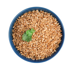 Bowl of buckwheat porridge with parsley isolated on white, top view