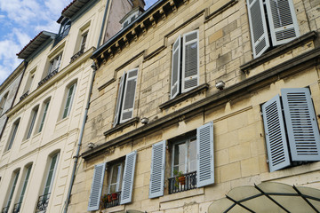 Fototapeta na wymiar Architecture of ancient city. Facade of residential houses in French Bayonne. Concept of touristic impressions in Nouvelle Aquitaine.